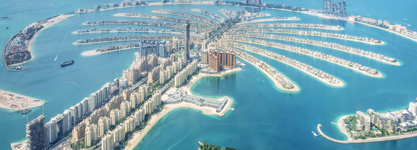 Aerial view of Palm Jumeirah in Dubai, ideal for travelers seeking fitness-friendly hotels amid blue waters and stunning scenery.