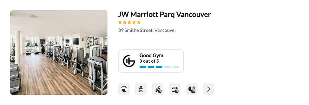 Stay fit while traveling in the modern JW Marriott Parq Vancouver gym, featuring diverse equipment, wood floors, and large windows.