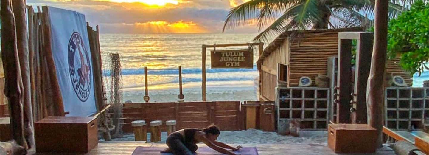 The "Jungle Gym" in Tulum, with ocean waves and palm trees, staying fit while traveling.