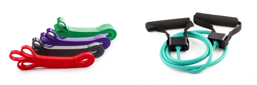 A set of five flat resistance bands and a green tube band with handles, perfect for fitness routines while traveling in hotels.